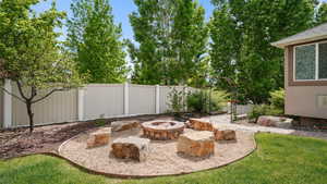 View of yard with an outdoor fire pit