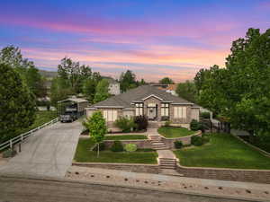 View of front of house featuring a detached carport, concrete driveway, and brick siding