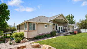 View of front of home with stucco siding, a patio area, french doors, and roof with shingles