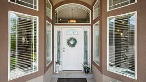 Doorway to property featuring stucco siding