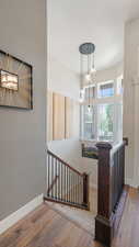 Stairway featuring wood finished floors and baseboards