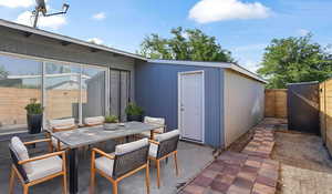 Virtually staged View of patio with outdoor dining area.