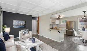 Virtually staged living area with coffered ceiling.