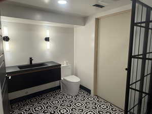 Bathroom with toilet and vanity