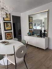 Dining space with wood finished floors and a textured ceiling