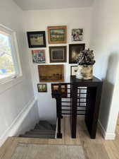 Staircase featuring wood finished floors and baseboards