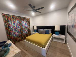 Bedroom with wood finished floors, recessed lighting, a ceiling fan, and baseboards