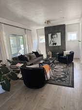 Living room featuring a textured ceiling, hardwood / wood-style flooring, and plenty of natural light