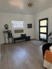Foyer featuring hardwood / wood-style flooring, baseboards, and a textured ceiling