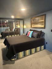 Carpeted bedroom with recessed lighting