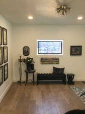 Living area featuring hardwood / wood-style flooring, baseboards, and recessed lighting