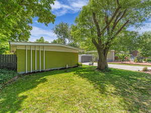 View of front yard and large shade tree
