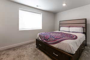 Bedroom featuring carpet floors and baseboards