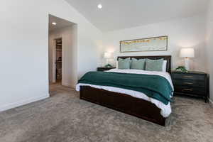 Bedroom featuring carpet floors, baseboards, vaulted ceiling, a spacious closet, and recessed lighting