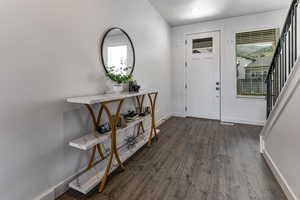 Entryway featuring dark wood-style floors, baseboards, healthy amount of natural light, and recessed lighting