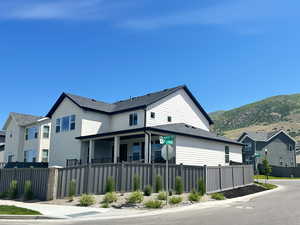 View of front of home with a mountain view and a residential view