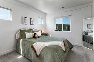 Carpeted bedroom with baseboards