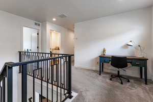 Carpeted home office featuring baseboards and recessed lighting