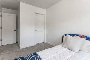 Carpeted bedroom with baseboards