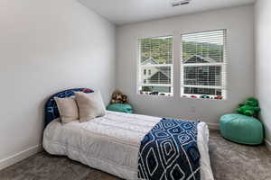 Carpeted bedroom featuring baseboards
