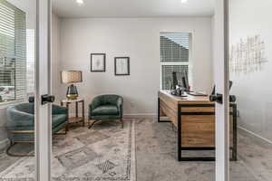 Carpeted office featuring baseboards and recessed lighting