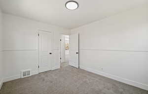 Unfurnished bedroom featuring carpet floors and baseboards