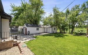 View of yard featuring a patio area and an outbuilding