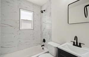 Full bathroom with toilet,  shower combination, and vanity