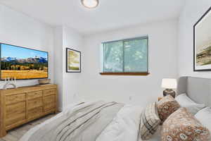 Bedroom featuring light wood-style flooring and baseboards