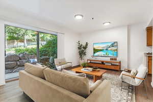 Living room with light wood-style flooring and baseboards