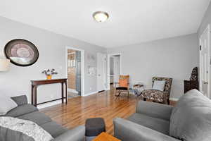 Living room with light wood finished floors and baseboards