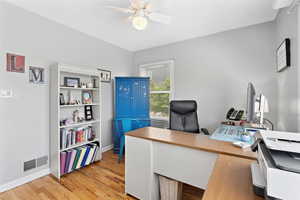 Office with ceiling fan, light wood-type flooring, and baseboards