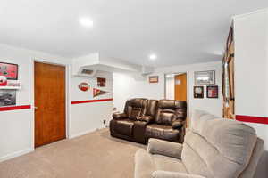 Carpeted living room featuring baseboards and recessed lighting