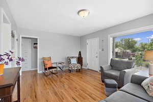 Living area featuring light wood-style floors and baseboards