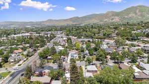 Aerial overview of property's location with mountains and nearby suburban area