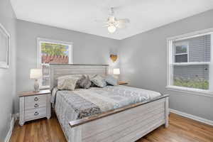 Bedroom featuring baseboards, wood finished floors, and ceiling fan