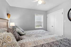 Bedroom with a ceiling fan and a closet