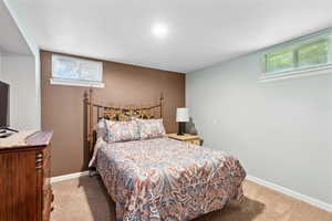 Carpeted bedroom featuring baseboards