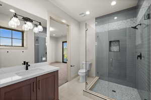 Bathroom featuring vanity, a stall shower, toilet, recessed lighting, and baseboards