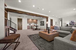 Living room with recessed lighting, light carpet, stairway, and baseboards