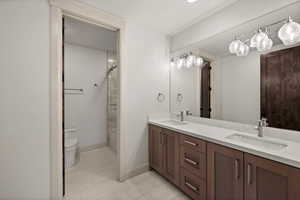 Full bathroom with double vanity, toilet, and shower / bath combination