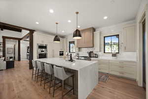 Kitchen with appliances with stainless steel finishes, decorative backsplash, plenty of natural light, a kitchen breakfast bar, and recessed lighting