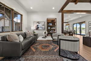 Living room featuring wood finished floors, recessed lighting, and beam ceiling
