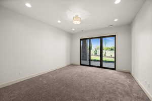 Empty room featuring recessed lighting, light carpet, and baseboards
