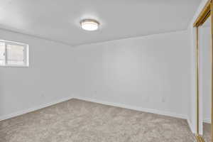 Carpeted empty room featuring baseboards