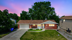 Ranch-style home with brick siding, a garage, concrete driveway, and a lawn
