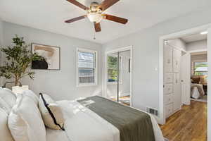 Bedroom with wood finished floors, a closet, and a ceiling fan