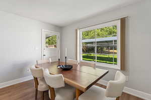 Dining area featuring baseboards and dark wood finished floors