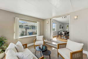 Sitting room with wooden walls and wood finished floors