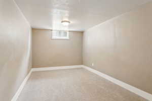 Below grade area with carpet flooring and baseboards